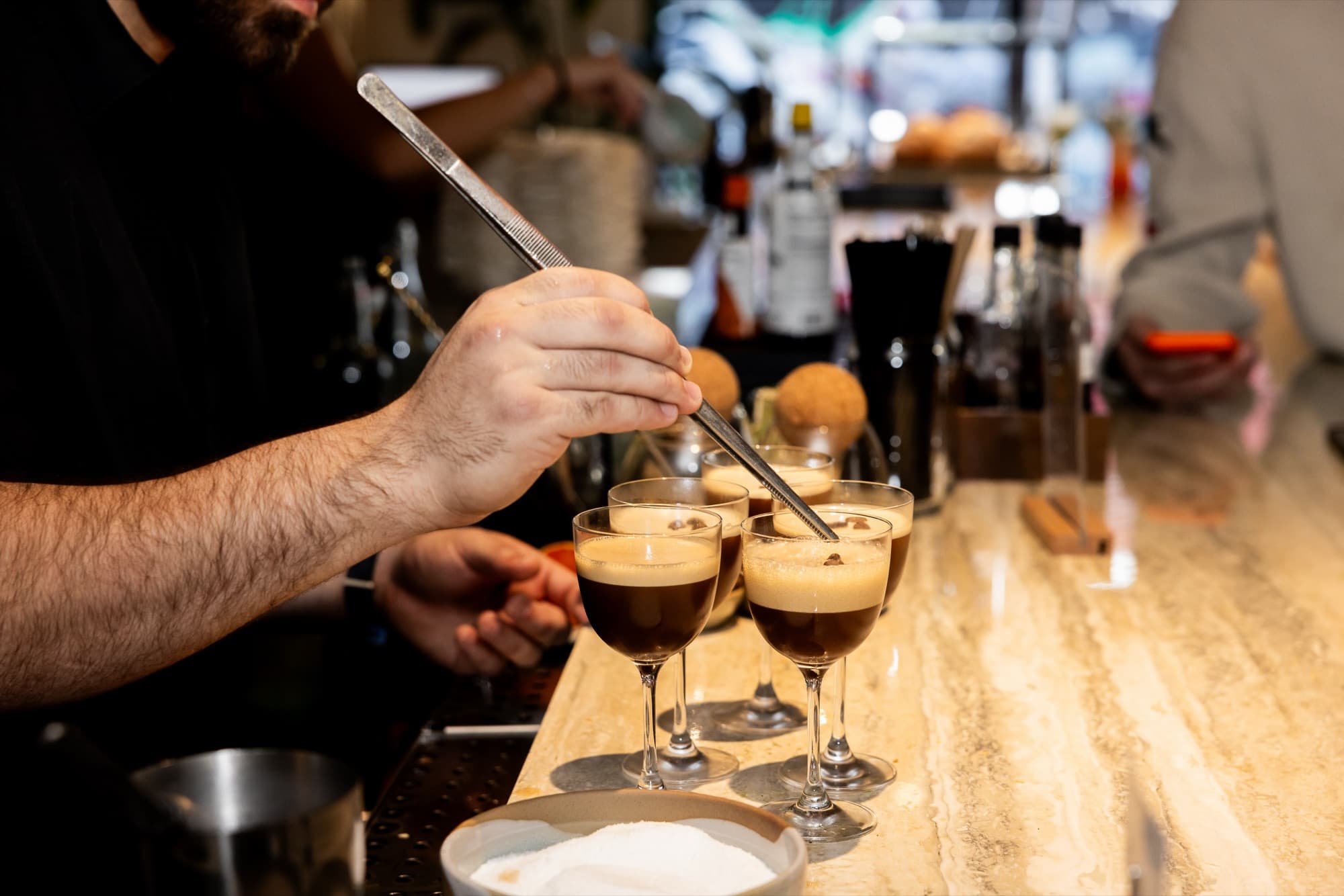 A bartender finishing espresso martinis at the Cotidiano bar