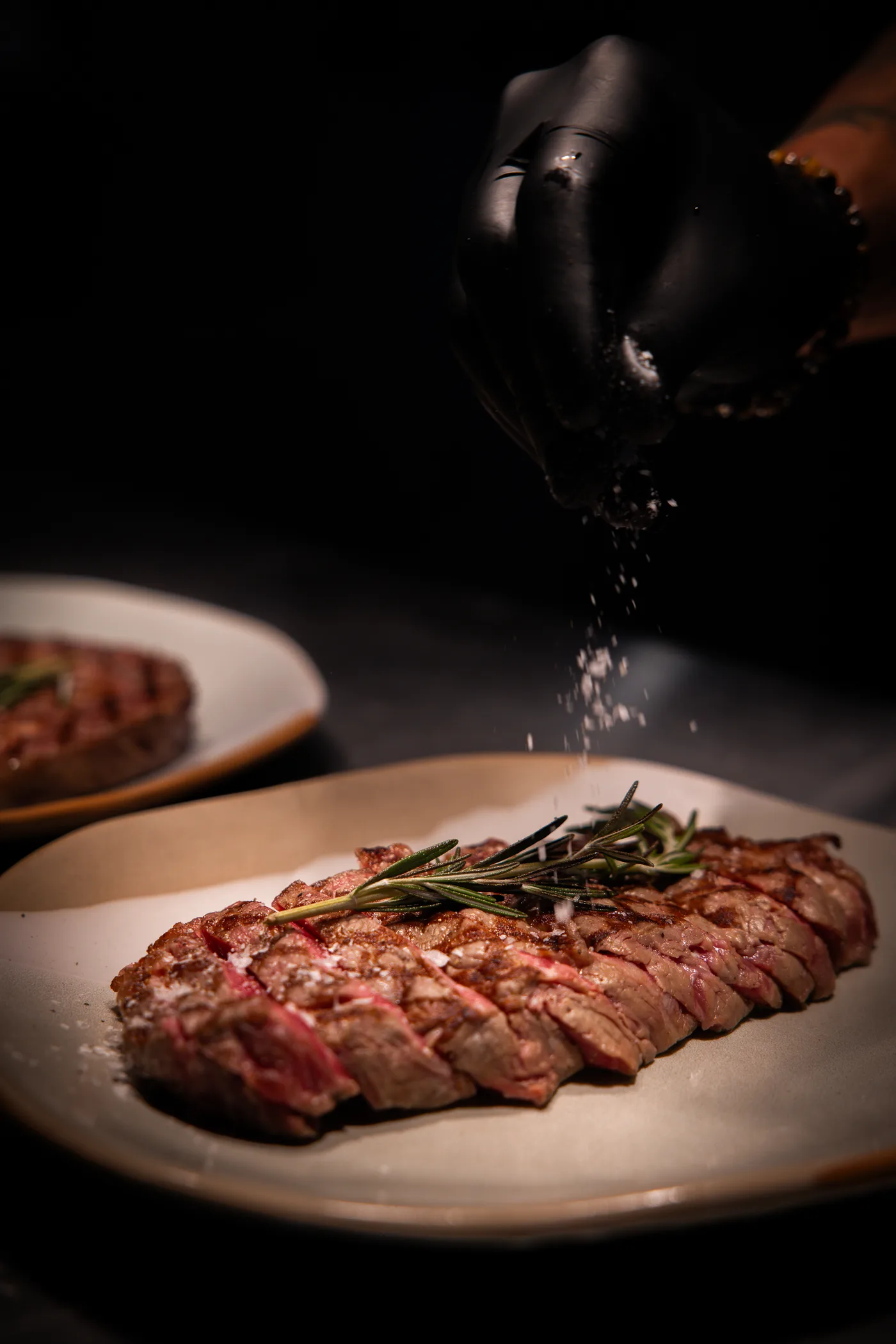 Sliced rib eye steak with rosemary and sea salt